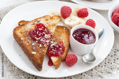 sweet breakfast - toasts with raspberries, banana and jam