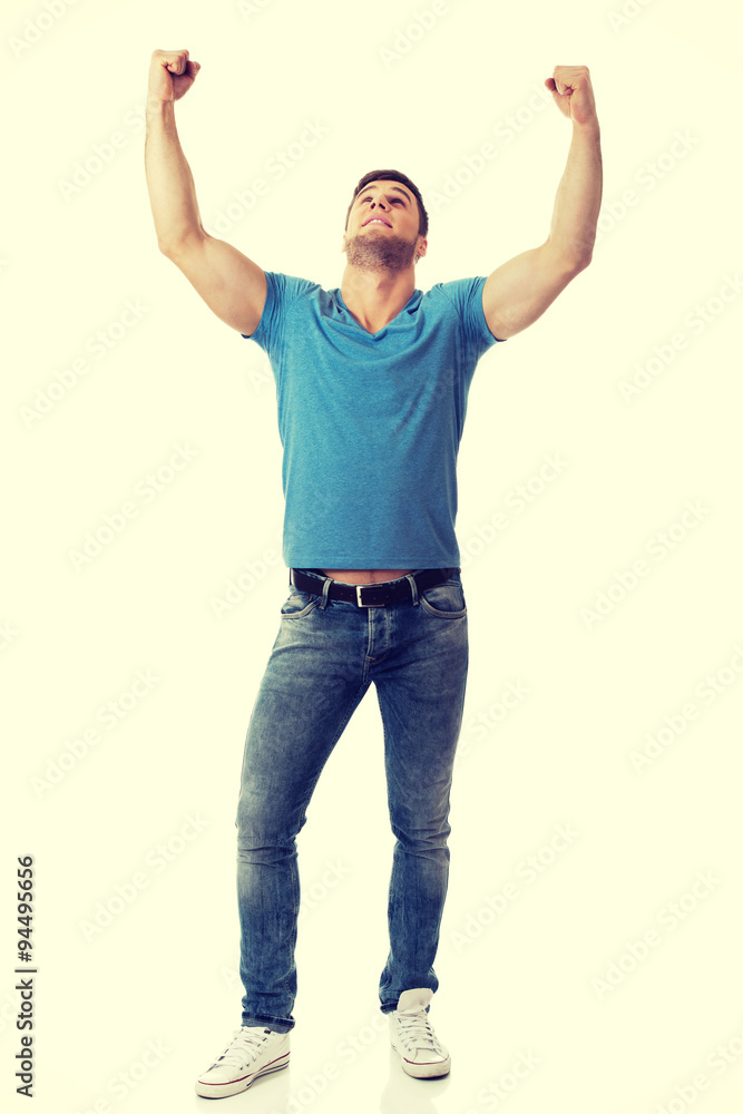 Young man with his arms up in victory gesture. Young man with his arms up in victory gesture.