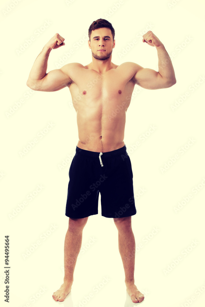 Young athletic man showing his muscles. Young athletic man showing his muscles.