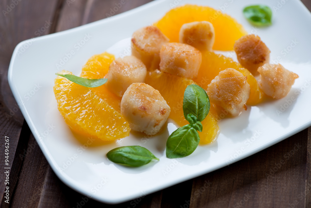 Roasted scallops with orange fillet, selective focus, closeup Roasted scallops with orange fillet, selective focus, closeup