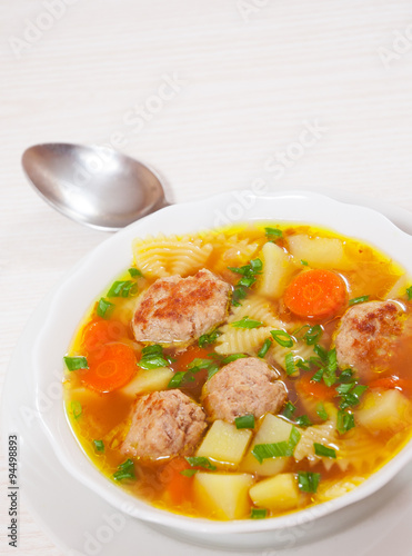 Soup with meatballs, farfalle pasta and vegetables