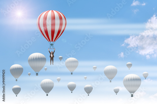 Businessman holding red balloon