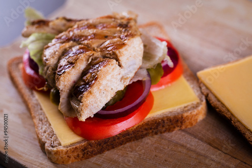 Fresh homemade grilled chicken sandwich on wood