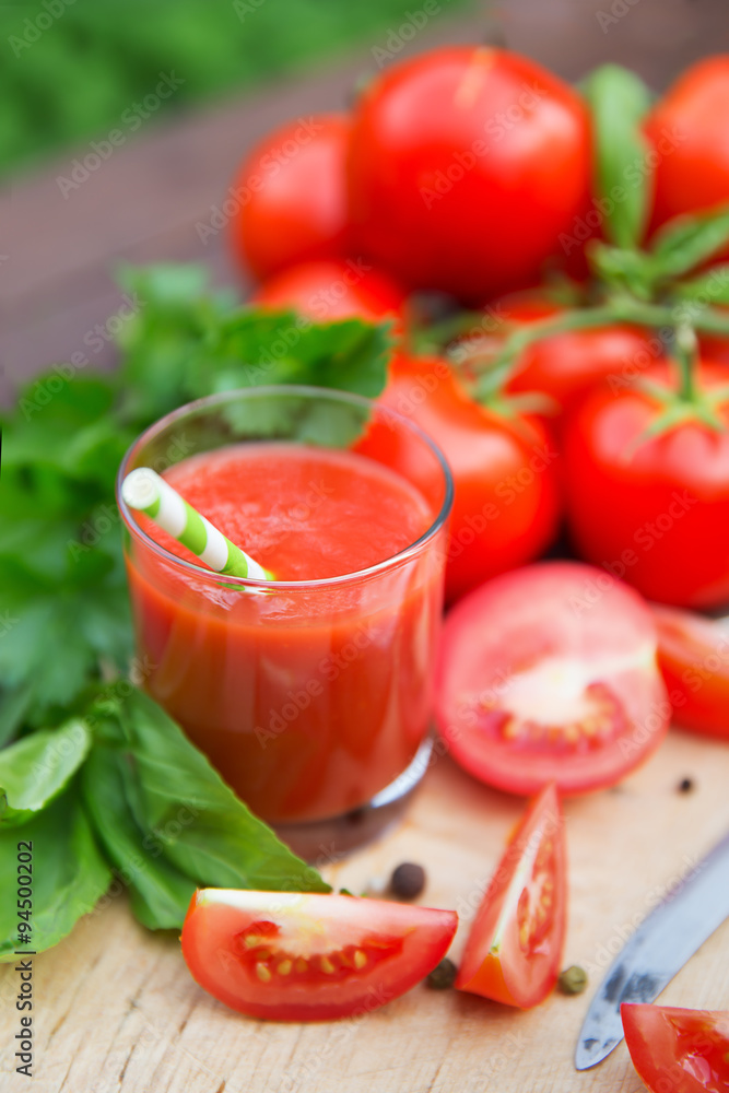 Fresh tomato juice on wooden background Fresh tomato juice on wooden background