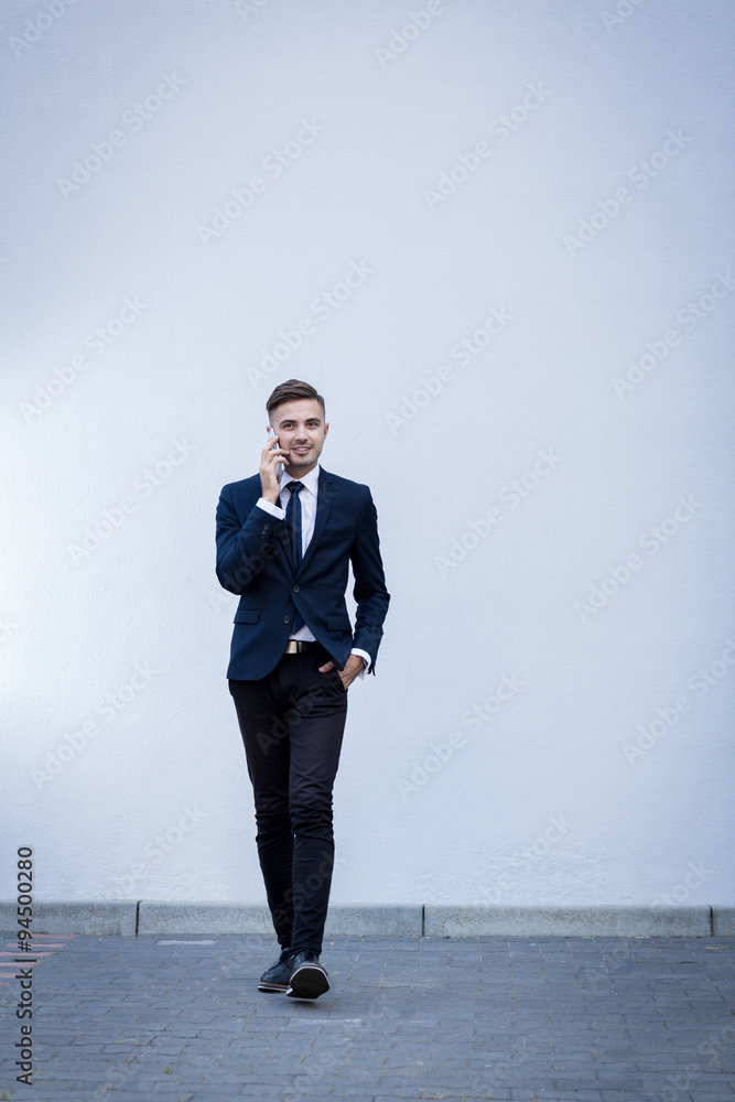 Young businessman walking and talking Young businessman walking and talking