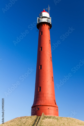 Red lighthouse in Ijmuiden with a beautiful blue sky