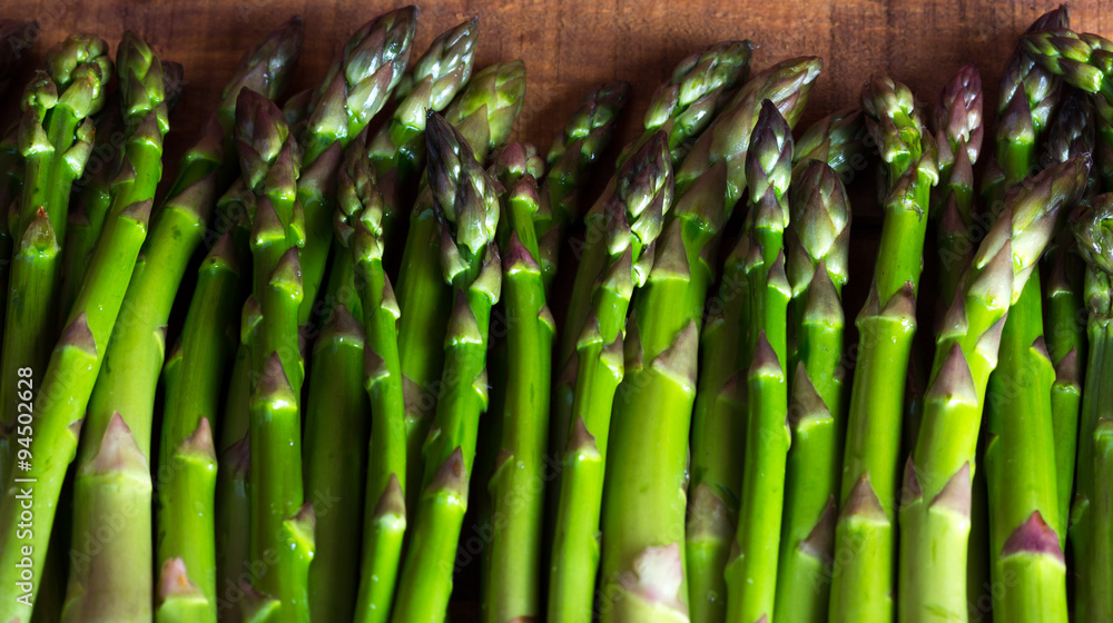 fresh green asparagus on dark wooden table. background fresh green asparagus on dark wooden table. background