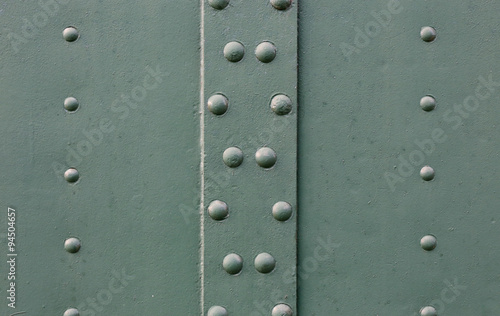Abstract detailed gray metal wall background texture with seams and rivets