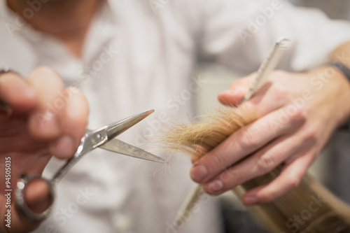 Hairdresser trimming hair
