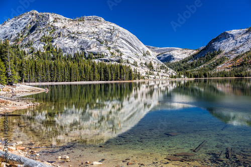 Lake Tenaya  Yosemite  CA  Perfect October day with clear skies  fall colors and the beautiful mountain reflecting in the crystal clear lake. 