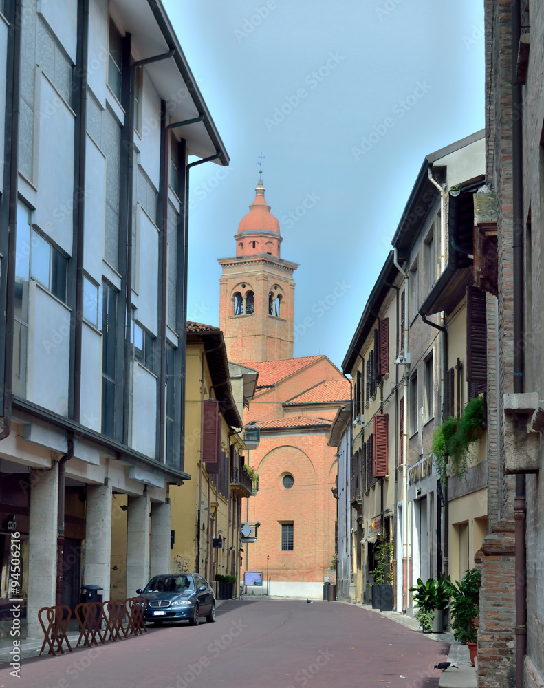 narrow street with a church in Rimini, Italy