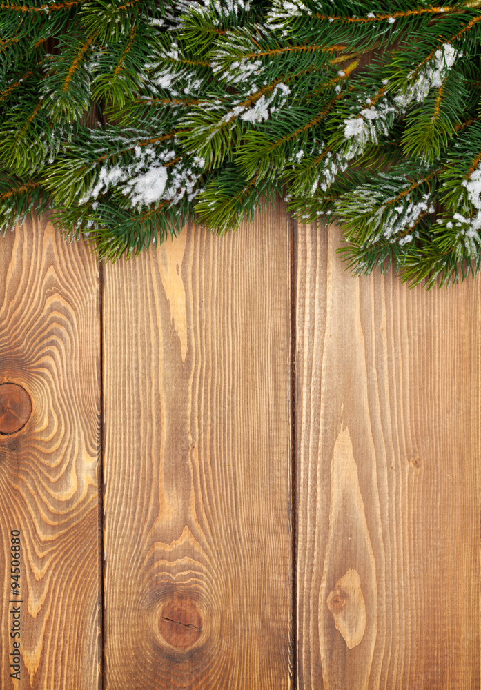 Christmas fir tree with snow on rustic wooden boardc Christmas fir tree with snow on rustic wooden boardc