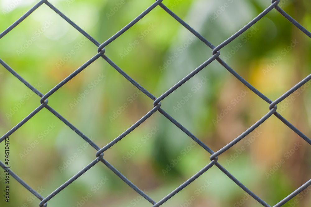 Metallic mesh fence closeup background texture