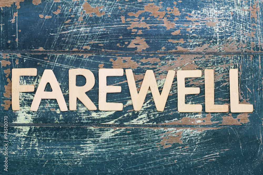 Word farewell written on rustic wooden surface