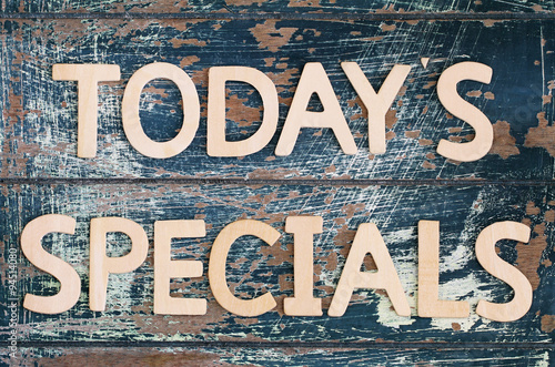 Today's specials written on rustic wooden surface
 photo