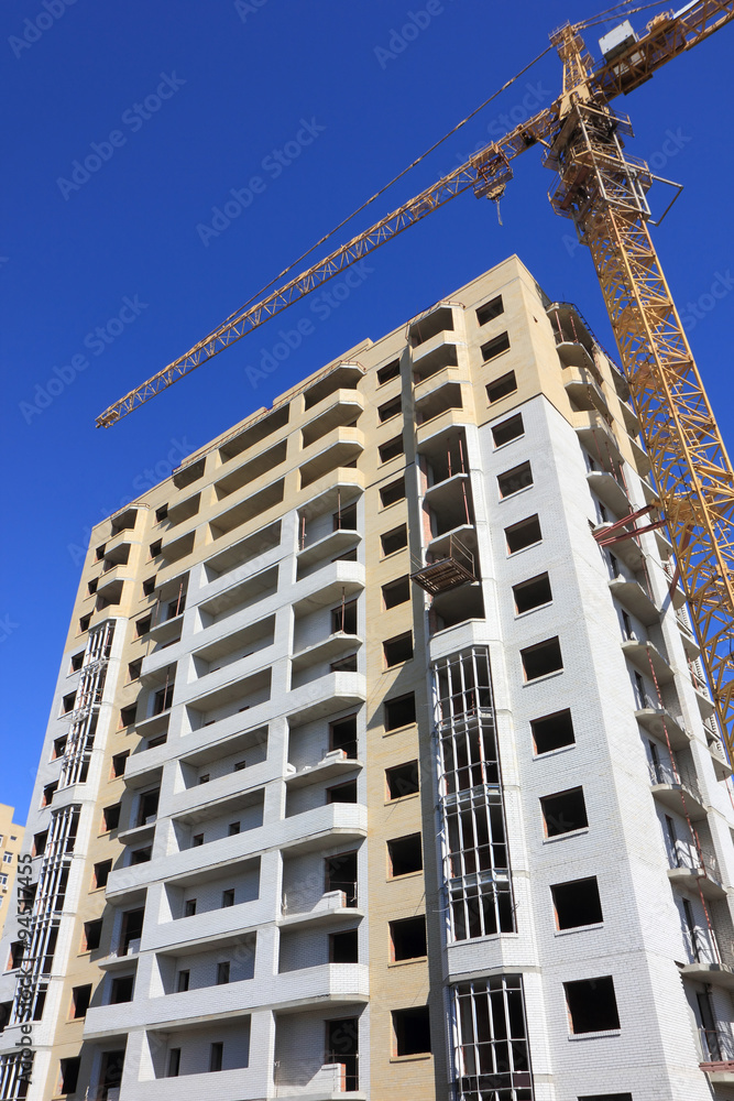 House under construction and tower crane House under construction and tower crane
