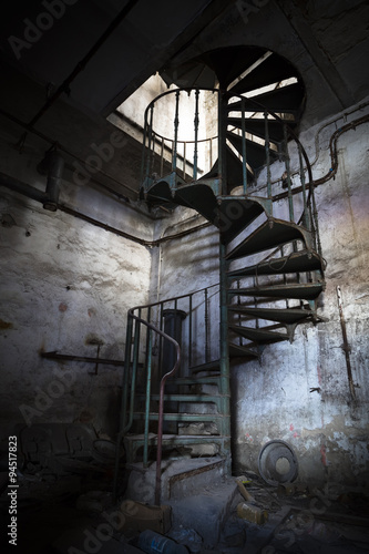 spiral staircase in an abandoned factory building