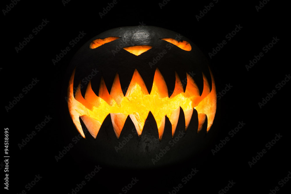 Fototapeta premium Spooky pumpkin in dark, isolated on black background