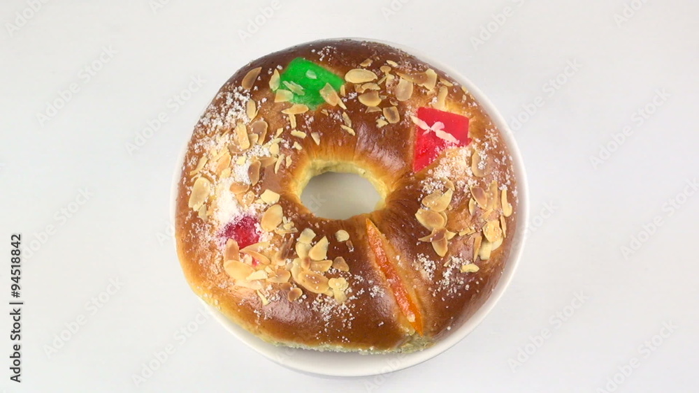typical spanish circular cupcake with candied fruit named roscon or three kings cake spinning and rotating on white background
typical spanish circular cupcake with candied fruit named roscon or three kings cake spinning and rotating on white background
