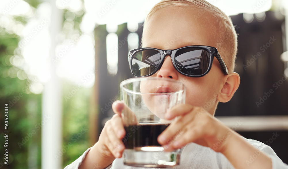 Cute hipster little boy in over sized sunglasses Cute hipster little boy in over sized sunglasses