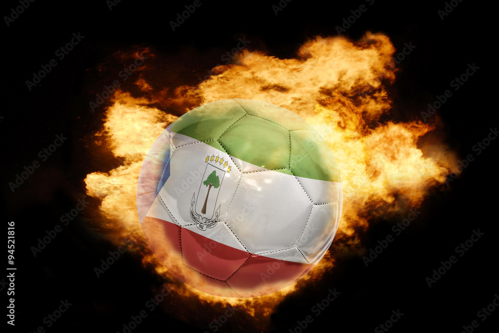 Fototapeta premium football ball with the flag of equatorial guinea on fire