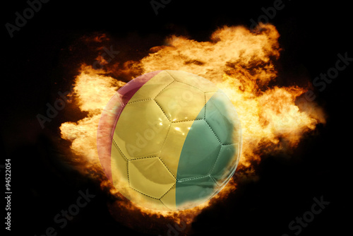 football ball with the flag of guinea on fire