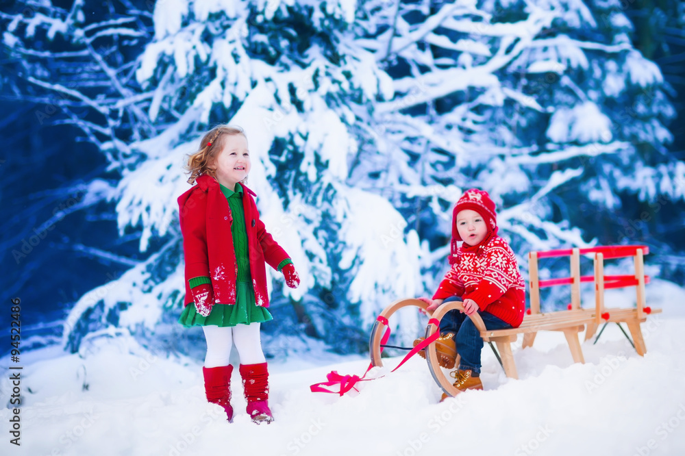 Kids having fun on a sleigh ride in winter Kids having fun on a sleigh ride in winter