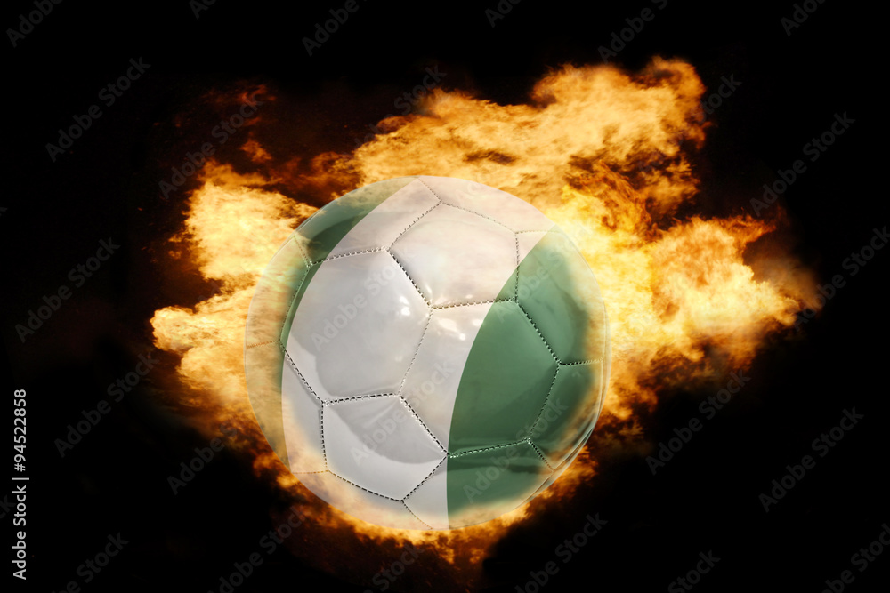 Naklejka premium football ball with the flag of nigeria on fire