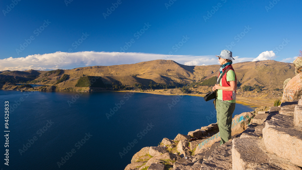 Tourist looking at view from above, Titicaca Lake, Bolivia
