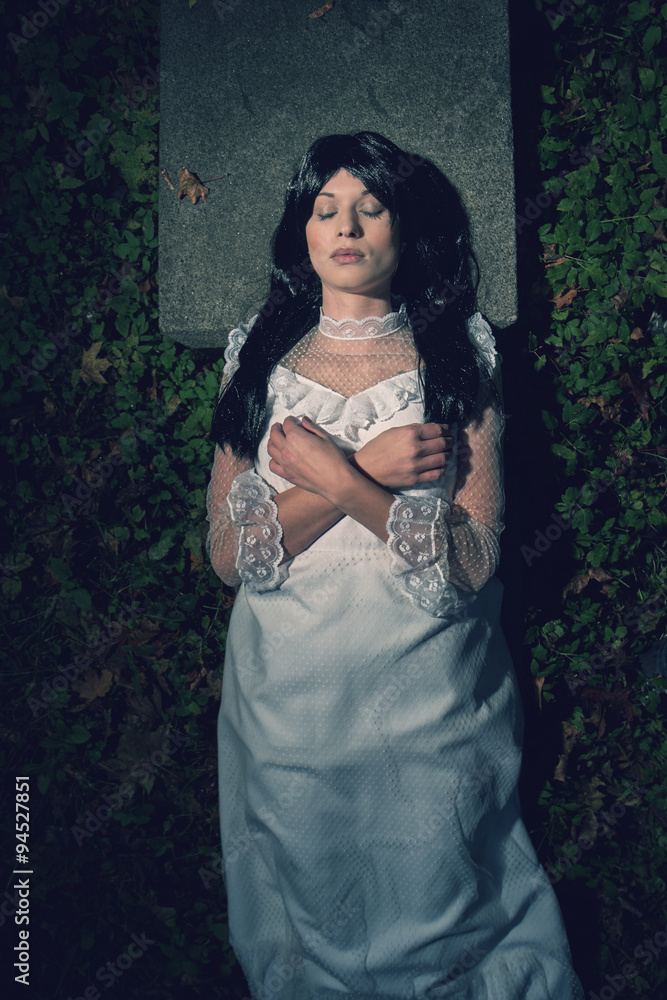 Fototapeta premium Witch from a crypt in the cemetery