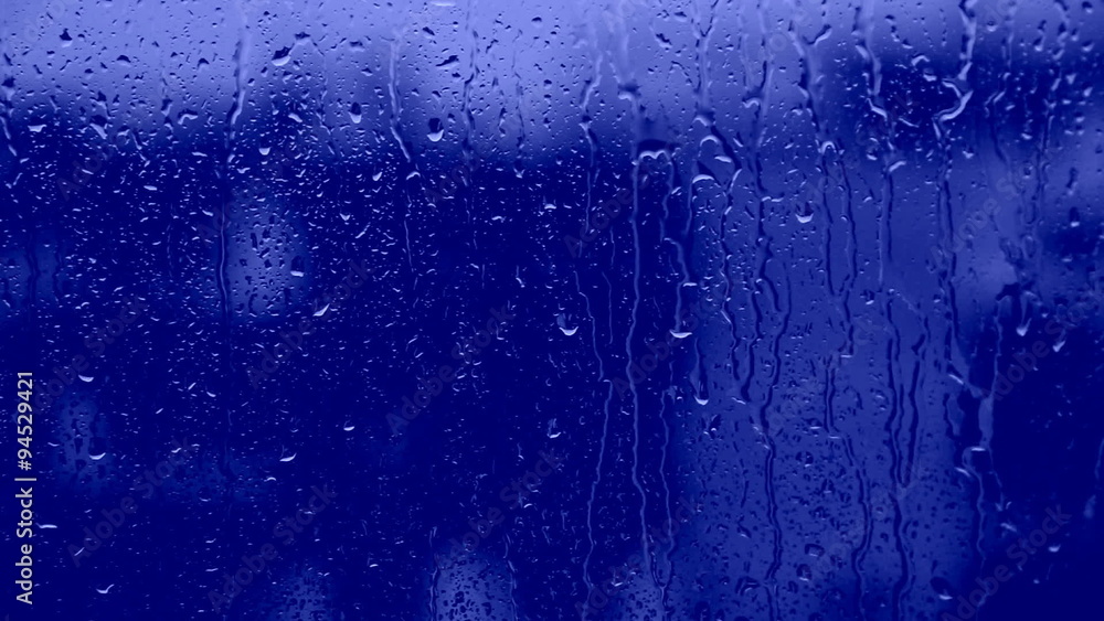 drop of water runs down the glass surface drop of water runs down the glass surface