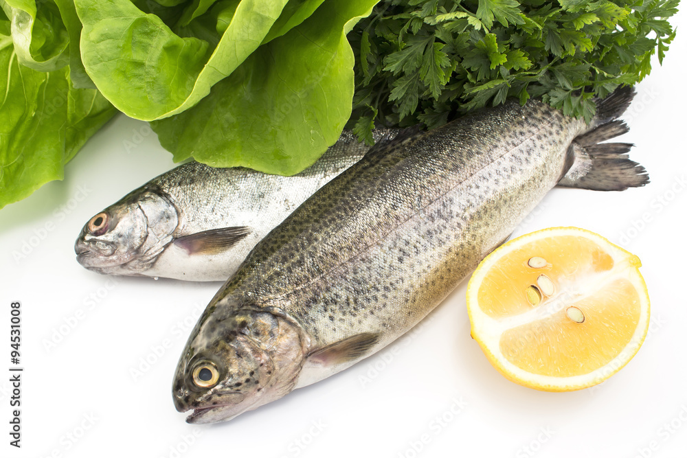 Two rainbow trout with lemon, parsley and lettuce