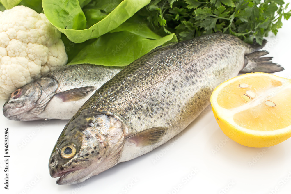 Two rainbow trout with vegetables and lemon Two rainbow trout with vegetables and lemon