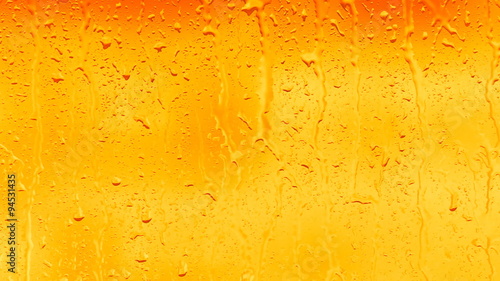 drop of water runs down the glass surface 
