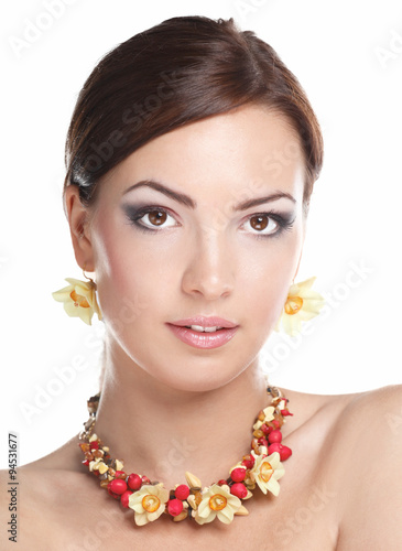 Portrait of young beautiful brunette woman in beads