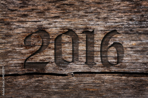 New year 2016 carved number in the old cracked wood with grunge look