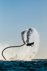 Acrylglasbilder Wasser Motorsport Flyboard-Silhouette im Sonnenuntergang  © Mrakor