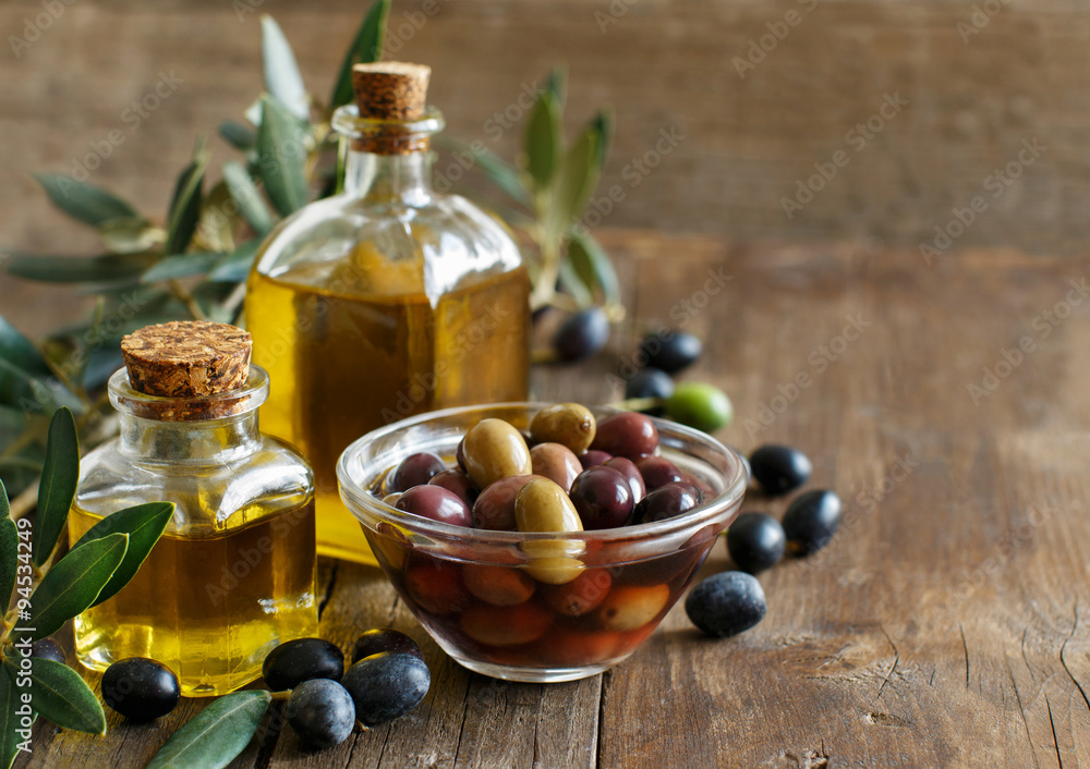 Olive oil and olives on wood background Olive oil and olives on wood background