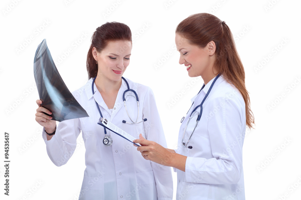 Two woman nurse watching X Ray image, standing in hospital Two woman nurse watching X Ray image, standing in hospital