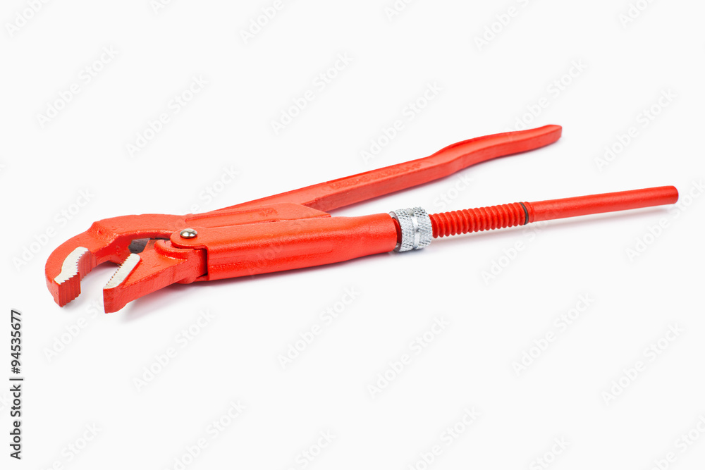 Close up new universal alligator spanner tool on white background Close up new universal alligator spanner tool on white background