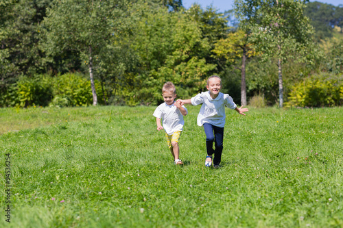 Boy and girl running on the lawn