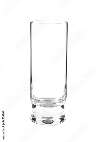 Empty long transparent glass isolated on white closeup. Vertical view