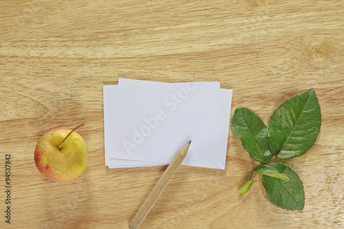 Stock photo .Note paper with apple on wood background