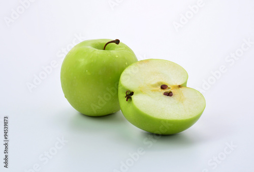 Ripe green apple and slice on white background