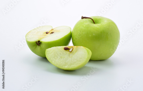 Ripe green apple and slice on white background
