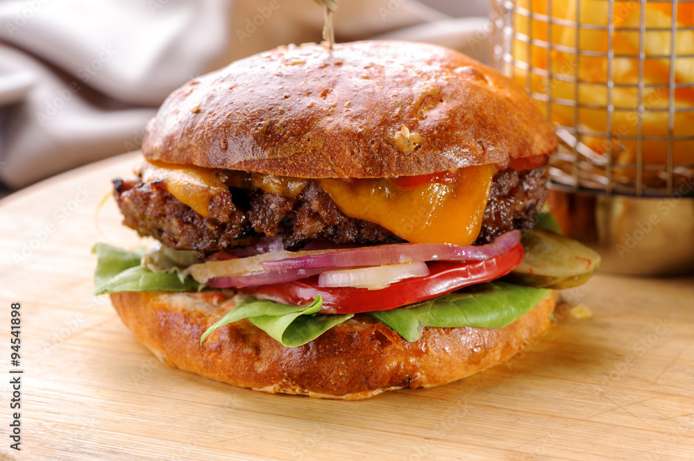 roasted beef hamburger with cheese and vegetables close-up 
