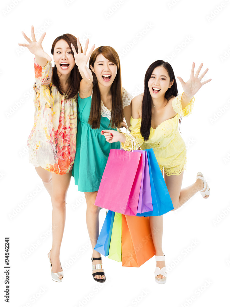 young woman group with shopping bags running and catching young woman group with shopping bags running and catching