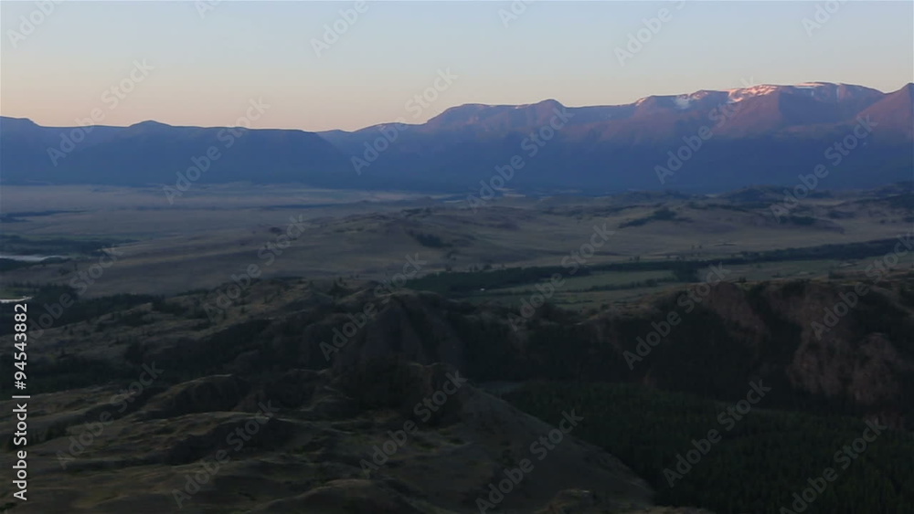 Panorama of Kuray steppe and North Chuya ridge at dawn.