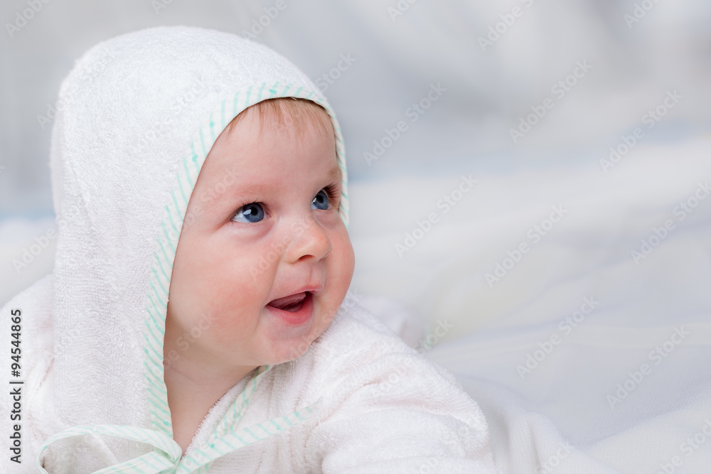 Smiling boy in white bathrobe laying on sofa Smiling boy in white bathrobe laying on sofa