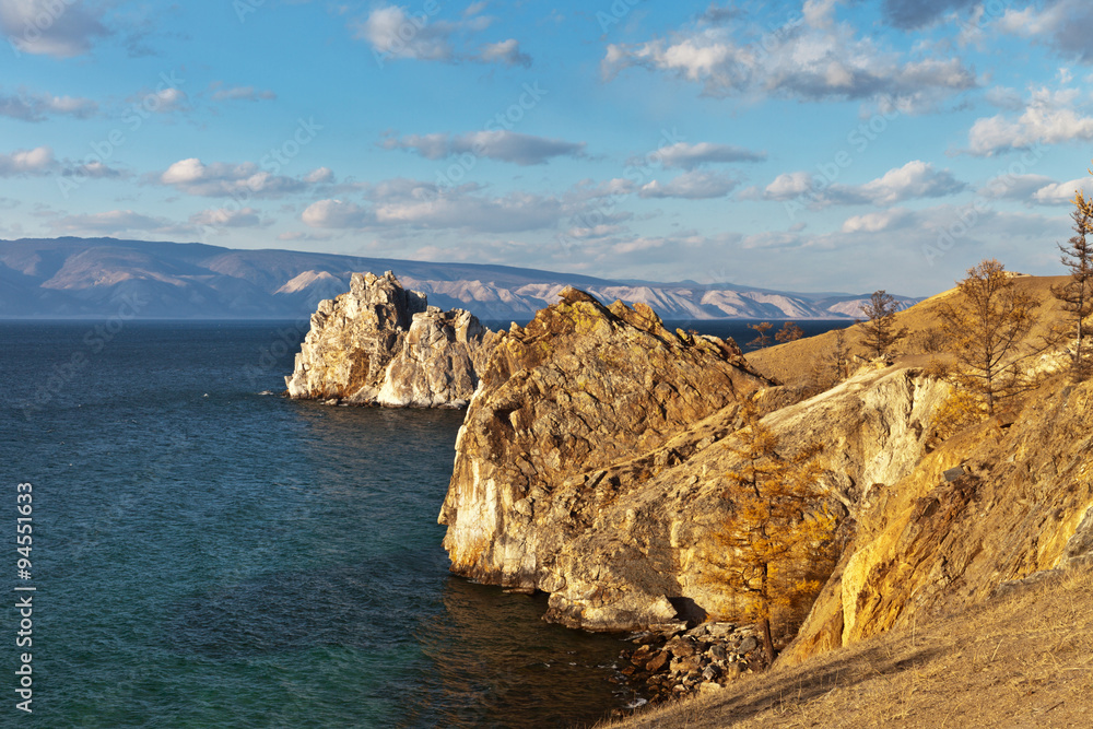 Lake Baikal autumn evening. Beautiful rocky coast of Olkhon Island at sunset light